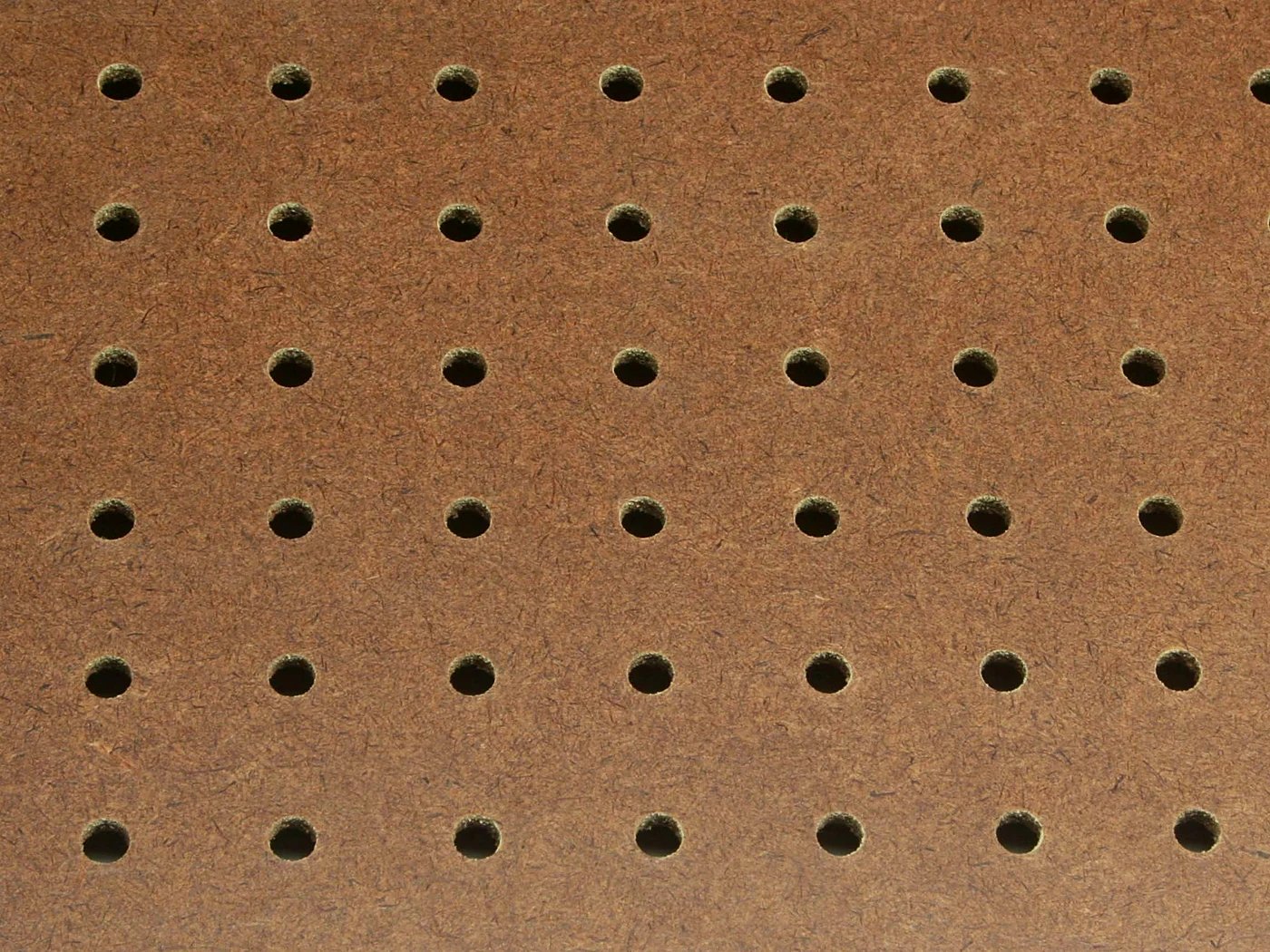 Perforated hardboard pegboard panel